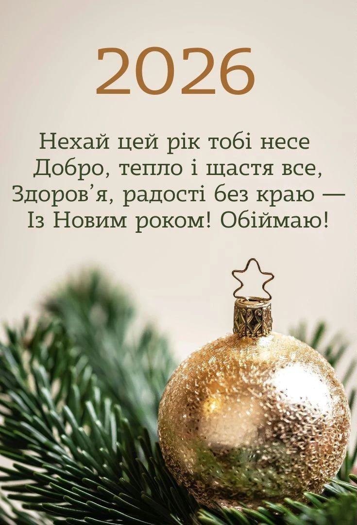Золотий куля на ялинці з привітанням на Новий рік.